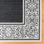 Tapis intérieur / extérieur en polypropylène tissé à plat à bordure à volutes crème blanc / noir Solterra Guilhermino-114551313