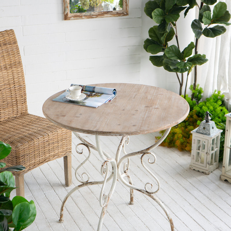 Table ronde en bois avec pieds à volutes en métal, blanc