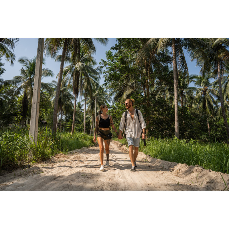 Caucasian couple walking through rainforest Wall Art on Canvas, 51cm H x 76cm W