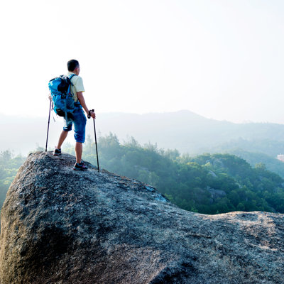 Male Hiker Standing On A Rock by Baona - No Frame Print on Canvas