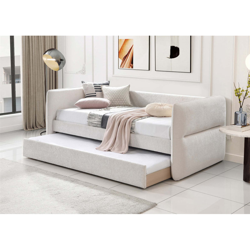 Lit de jour moderne avec couchette coulissante, capitonnage à boutons et garniture cloutée pour une utilisation polyvalente dans la chambre à coucher ou le salon.