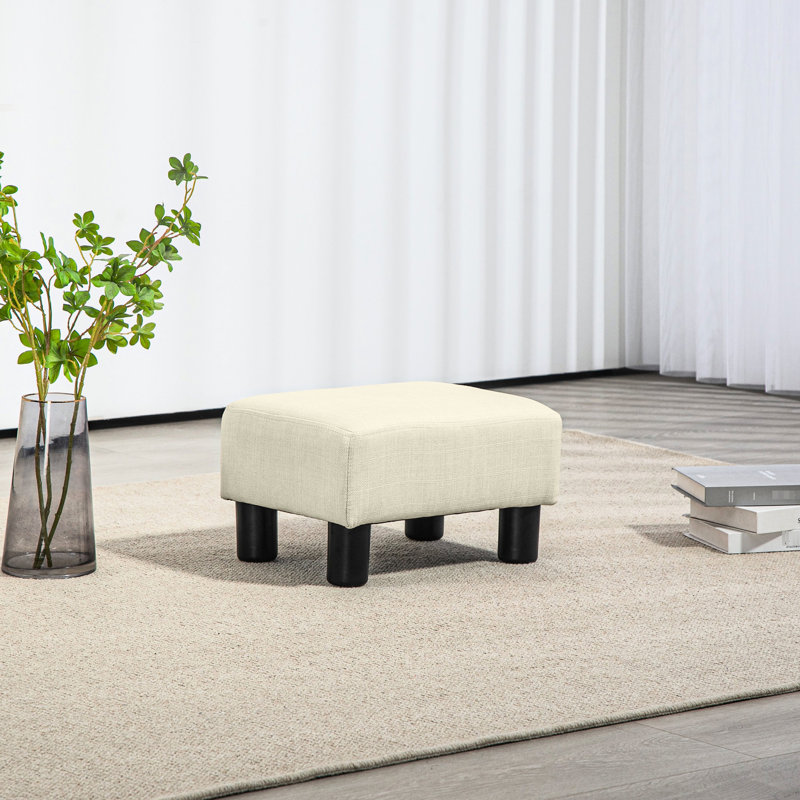 Repose-pieds cubique beige avec housse en lin, petit espace de repos, pièce