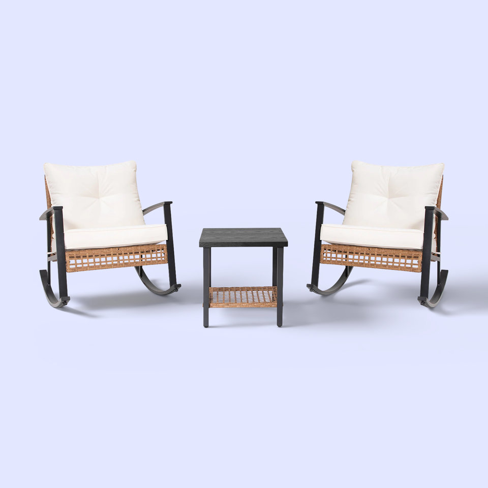 Two rocking chairs and a side table on a light blue background.