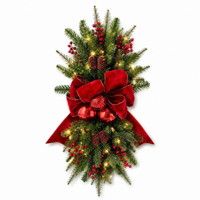 Décoration de porte d'entrée lumineuse en forme de larme, ornée d'un nœud rouge, de baies et de pommes de pin, idéale pour décorer un porche pendant les fêtes d'hiver. Décoration murale pour porche et décoration hivernale.