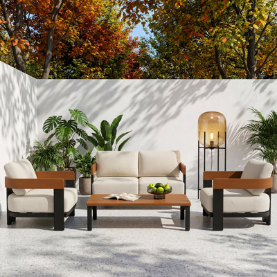 Ensemble de meubles de patio 4 pièces avec cadre noir et coussins beiges