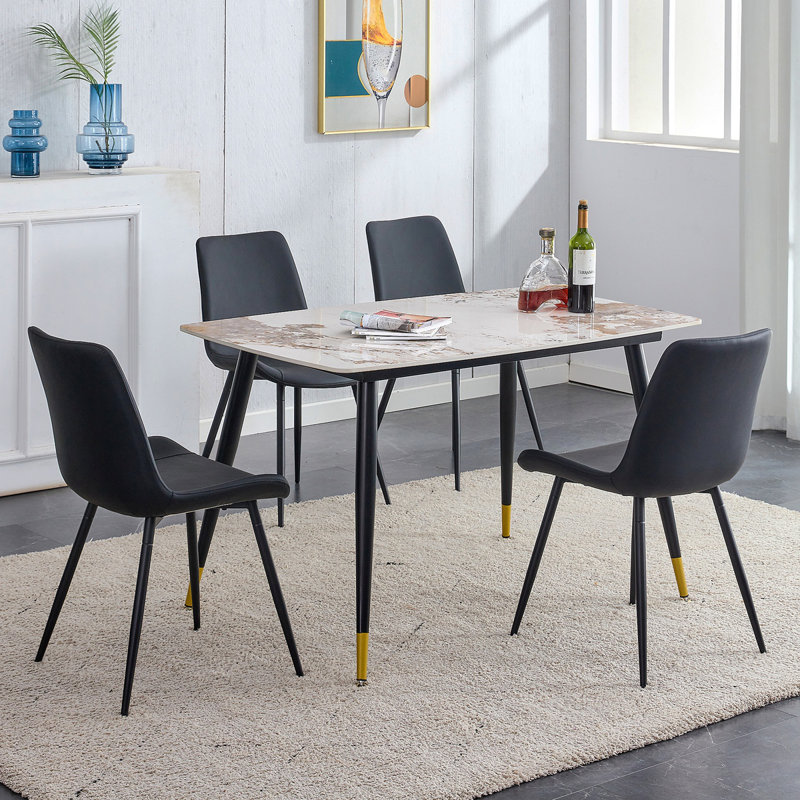 Ensemble table et chaises Ensemble de table de salle à manger en pierre frittée de 28,4 po x 28 po - 4 chaises en polyuréthane artificiel noir avec coussins courbés et élargis.