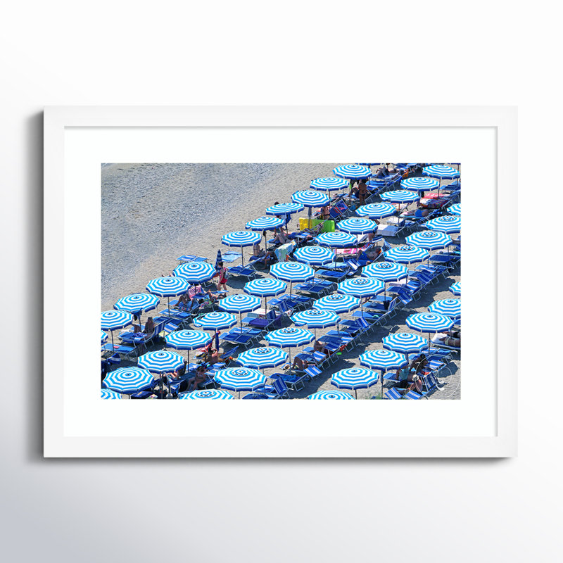 " Umbrellas Of Monterosso " by Rachel Dowd, 18.56" H x 25.25" W x 0.88" D, White Framed Paper