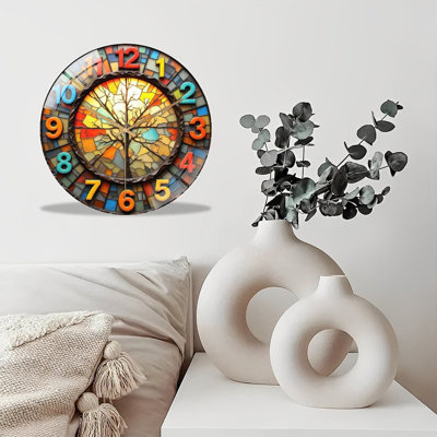 Stained‑glass wall clock with bare‑tree mosaic art, vivid multicolor tiles, bright flat 2D numerals, silent‑sweep quartz movement, tempered glass front. Artistic bohemian decor, ideal for living rooms, art studios and home spaces.