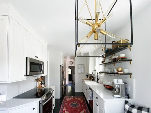 white kitchen with modern chandelier