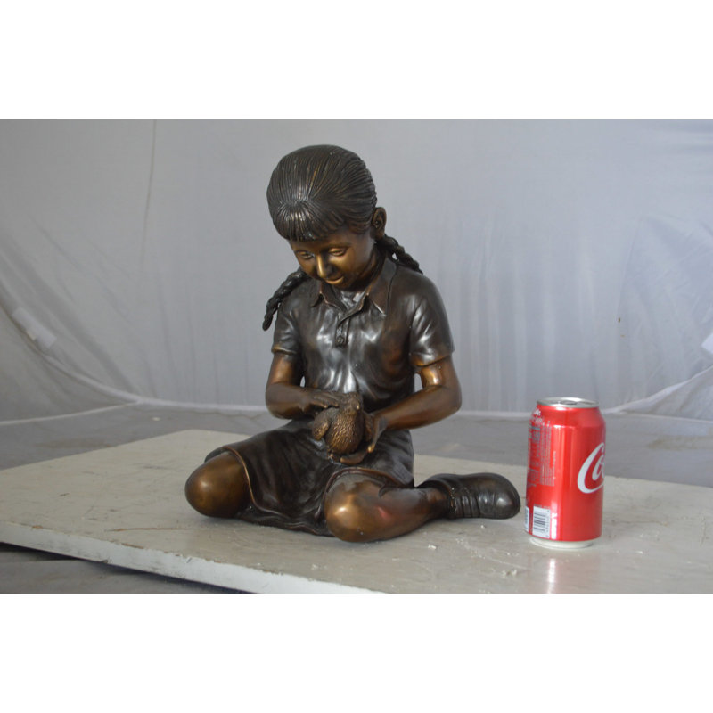 Evandale Young seated girl with bird bronze statue - Size: 12"L x 9"W x 14"H.