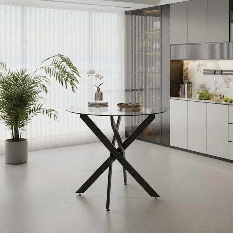 Table de salle à manger ronde en verre avec pieds noirs, design minimaliste moderne pour des espaces compacts et une salle à manger élégante