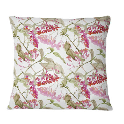Coussin décoratif à motif de fleurs rouges et de feuilles vertes sur fond blanc
