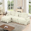 Canapé trois places de style années 50 avec accoudoirs évasés, jupe à volants amovible et plissée, tissu chenille beige et blanc, confortable, modulable et détachable.