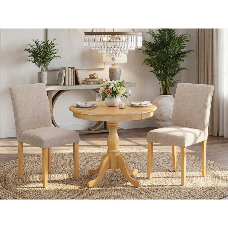 3 Piece Dining Set Contains a Round Kitchen Table with Pedestal and 2 Light Tan Linen Fabric Parson Dining Room Chairs, Oak