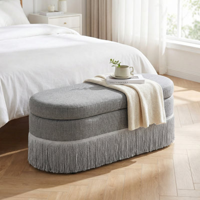 Repose-pieds ovale rembourré avec rangement à franges et couvercle relevable pour une utilisation multifonctionnelle dans le salon ou la chambre à coucher