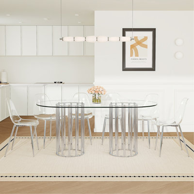 Ensemble de table et de chaises Table de salle à manger ovale en verre trempé de 71 pouces de style luxueux à double colonne argentée. Jumelé avec 6 chaises en plastique transparent avec des pieds en métal argenté.