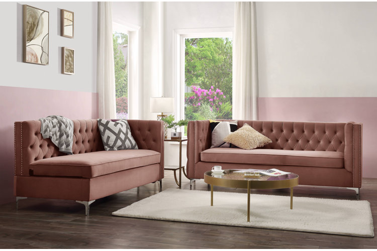 Pink living room with pink velvet sofas and white and pink walls.