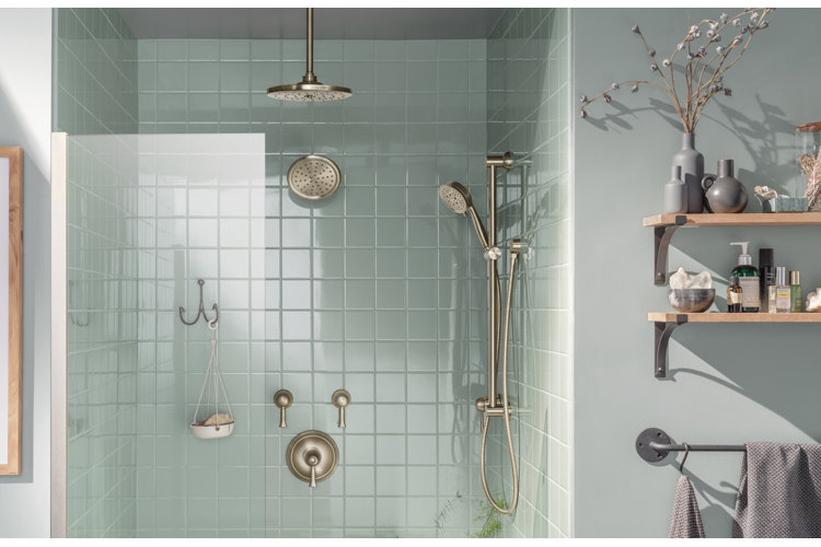 a light blue tiled shower with a rain shower head mounted on the ceiling, a rain shower head mounted on the wall, and a shower hose