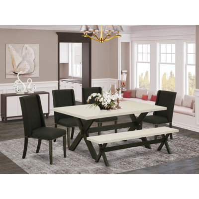 L'ensemble de salle à manger 6 pièces comprend une table de salle à manger rectangulaire avec pieds en X et 4 chaises Parson en tissu noir avec banc, noir brossé