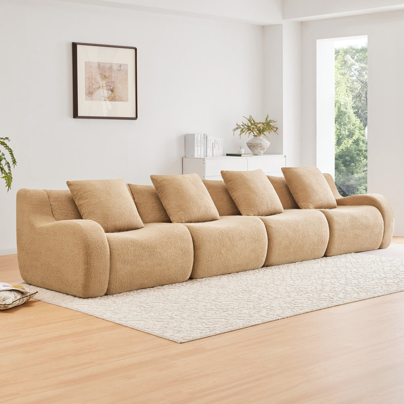 Fauteuil sans os Camel, doté d'un design ergonomique et d'accoudoirs incurvés, avec une base en tissu confortable, conçu pour le salon.