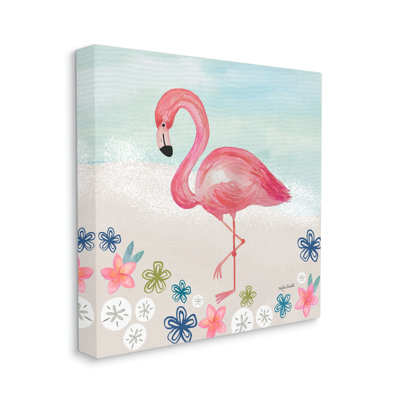 Flamant rose entre des dollars de sable et des fleurs sur le rivage gris