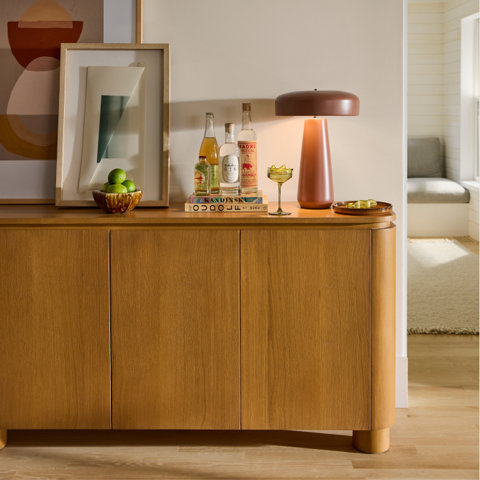 Bar setup with cocktail on top of cabinet.