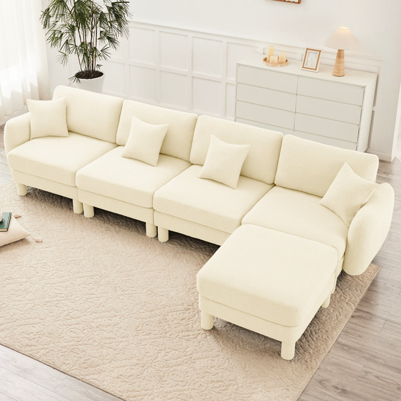 Canapé convertible en L à 4 boucles en tissu avec pieds en forme de coquillage, amovibles et cylindriques de couleur beige, pour un rassemblement social modulaire A Quiet Time Alone