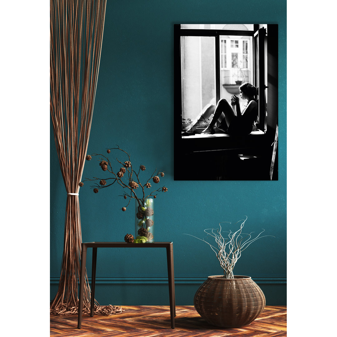 Woman Sitting on a Windowsill - Ungerahmtes Foto auf Glas