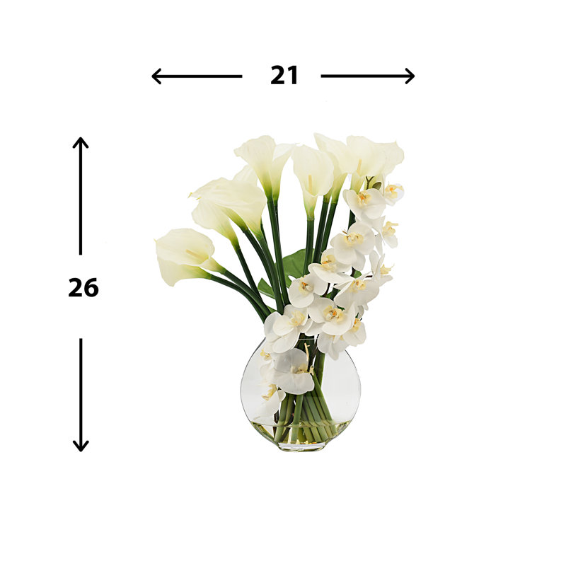 Orchids, Calla Lily And Philodendron Leaves Arranged In A Clear Circular Glass Vase
