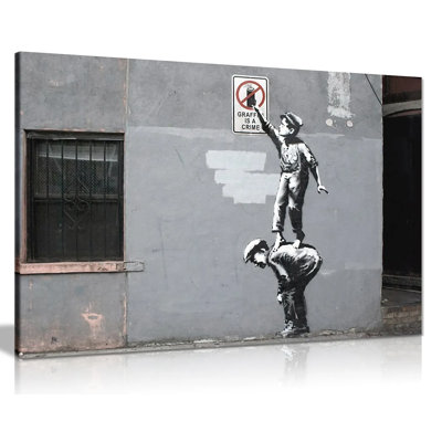 Graffiti Is A Crime by Banksy - Wrapped Canvas Print