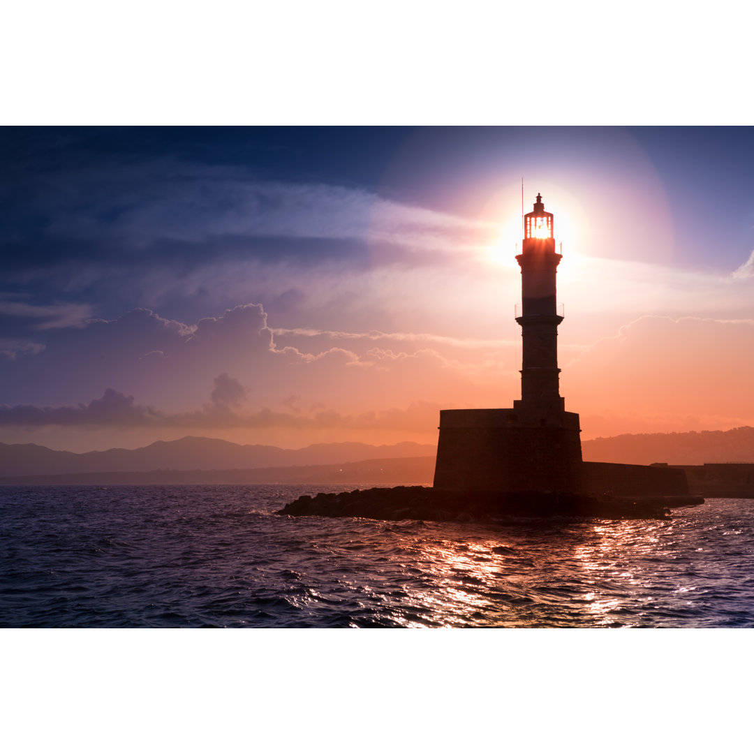 Lighthouse On Sunset by Proslgn - Wrapped Canvas Print