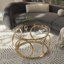 Table basse moderne avec plateau rond en verre et structure circulaire en métal-1217319521