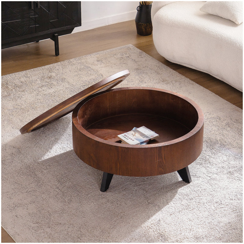 Table basse ronde avec rangement caché, design Mid-Century moderne, finition en bois foncé et pieds noirs pour le salon