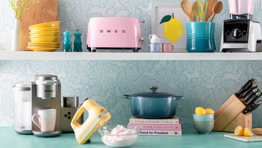 Kitchen scene with SMEG toaster, Vitamix blender, and Salad for President cookbook.
