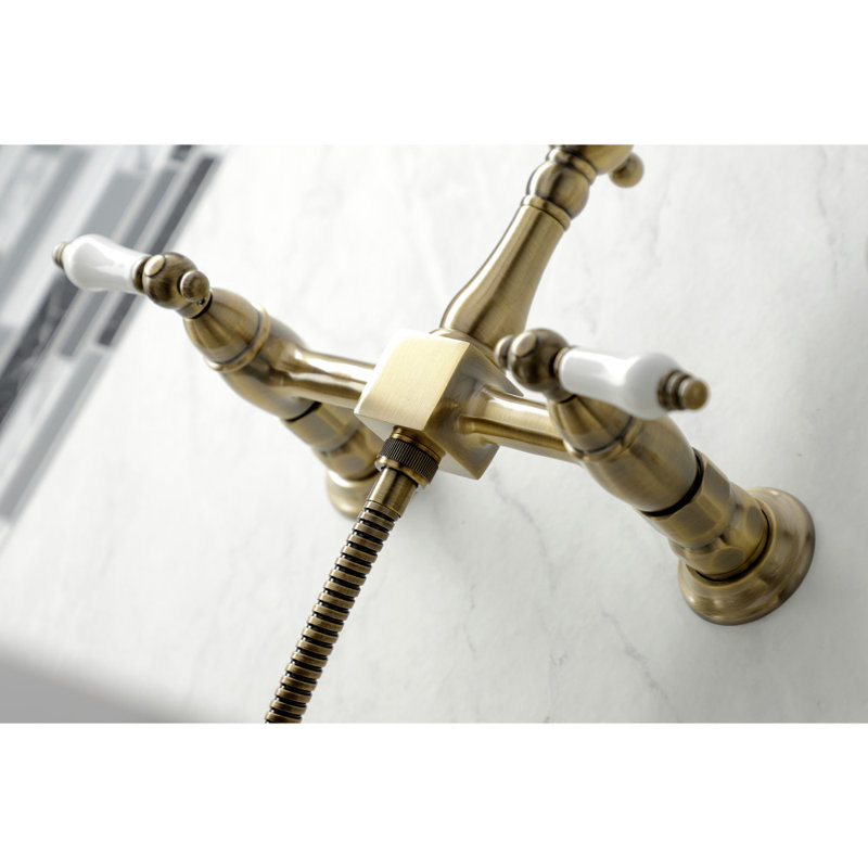 Kingston Brass Heritage Double-Handle 3-Hole Wall-Mount Bridge Kitchen Faucet with Brass Sprayer, Vintage Brass