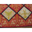 Tapis rustique rouge à motif géométrique tissé à plat