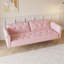 Un canapé-lit de 69,7 po de long recouvert de velours rose, doté d'une garniture cloutée et d'un coussin décoratif assorti