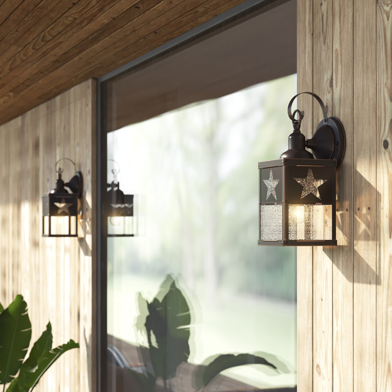 Vandervoort 13 in. H 1-Light Burnished Bronze Rustic Star Outdoor Wall Sconce made of Durable Steel, Clear Seeded Glass Shade, LED Compatible, Use for Exterior Porch Patio Front Door or Garage