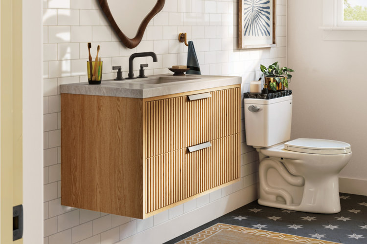 modern bathroom with a fluted floating wood bathroom vanity, patterned tile, and an abstract vanity mirror