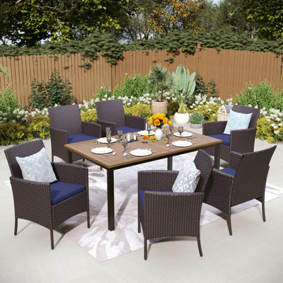 Leonard Rectangular 6 - Person 64" Long Dining Set with Cushions and Umbrella Hole