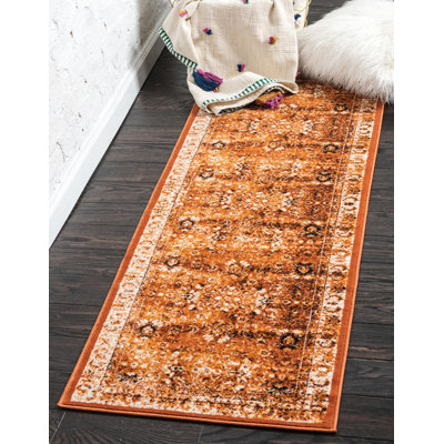 Tapis à motif floral terre cuite / orange Yareli