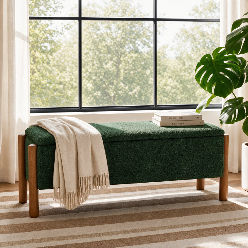 Upholstered storage bench with walnut legs for studio apartment