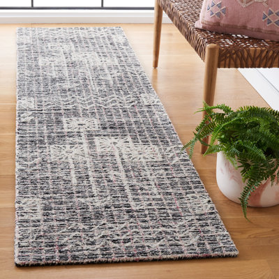 Hadwig Hand Tufted Wool/Cotton Floral Rug in Black/Ivory