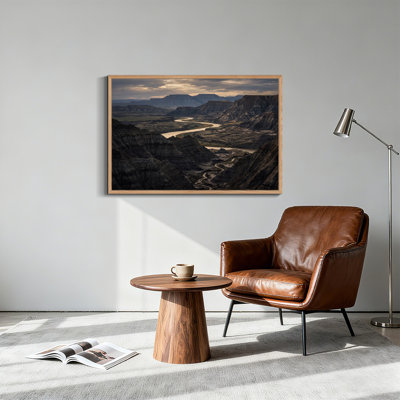 «Winding River Through Rugged Badlands Under Cloudy Sky», art mural