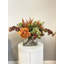 Heather, hortensia et chardon dans un vase en verre