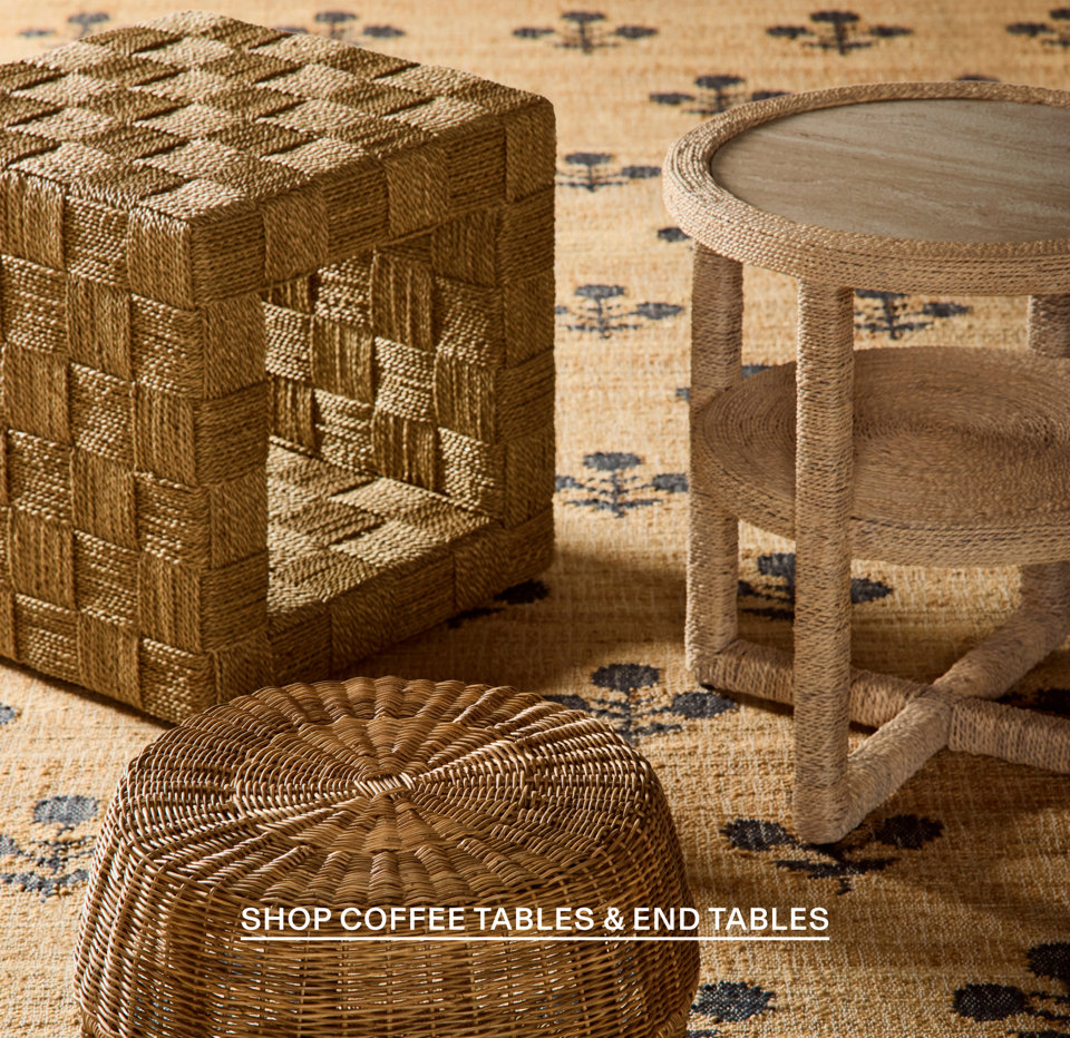 Shop Coffee Tables & End Tables - wicker and rattan furniture pieces including cube side table, round end table, and ottoman on patterned rug