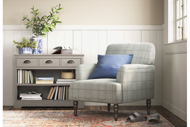 traditional-style living space with an armchair and bookcase