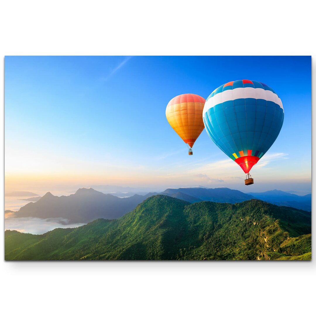 Leinwandbild Bunte Heißluftballons über Bergkette