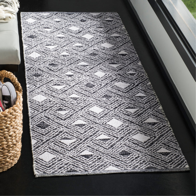 Tapis géométrique noir / ivoire tissé à plat à la main Dominica