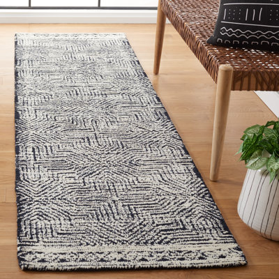 Tapis touffeté en laine / fil pour animaux de compagnie Friedi en ivoire / noir